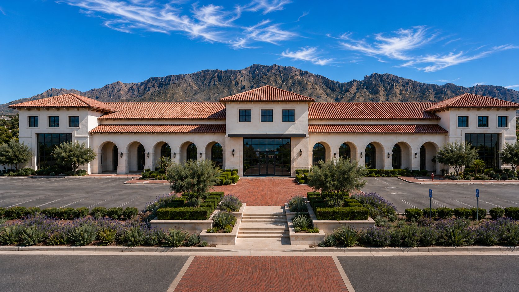 Jardines at Cimarron Spanish Revival campus building framed by the Franklin Mountains